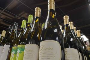 Bottles of wine are displayed on June 29, 2022, at an Anchorage liquor store. Alaska is the first U.S. state to require that businesses post signs warning that alcohol consumption raises cancer risks. (Photo by Yereth Rosen/Alaska Beacon)