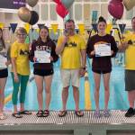 Glacier Swim Club senior Lucia Chapell (Colorado College signee), coach Lisa Jones, senior Pacific Ricke (Bates College signee), Coach of the Year Scott Griffith, Female Athlete of the Year Emma Fellman (University of Minnesota signee) and coach Seth Cayce are shown Friday at the 2025 Alaska State Swimming Championships in Anchorage. (Photo courtesy GSC)