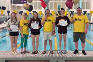 Glacier Swim Club senior Lucia Chapell (Colorado College signee), coach Lisa Jones, senior Pacific Ricke (Bates College signee), Coach of the Year Scott Griffith, Female Athlete of the Year Emma Fellman (University of Minnesota signee) and coach Seth Cayce are shown Friday at the 2025 Alaska State Swimming Championships in Anchorage. (Photo courtesy GSC)