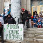 Geoff Kirsch and students from Sayéik Gastineau Community School sing during a rally for early education funding at the Alaska State Capitol on Tuesday, April 29, 2025. (Jasz Garrett / Juneau Empire)