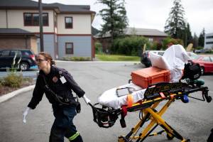 Capital City Fire/Rescue firefighter Jenna Habig transports a hospital gurney in an undated photo. (Photo courtesy of Jesse Inman)