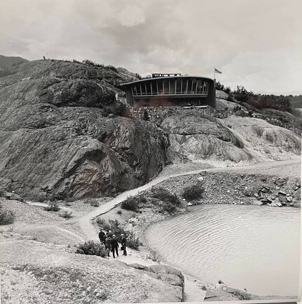 Barren landscape around Mendenhall Glacier Visitor Center in 1962. In the 1940s, the glacier drained as a roaring torrent through the chasm to the left where now there is a trail to Nugget Falls. (Courtesy MRV Architects)