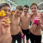 Glacier Swim Club swimmers Andy Huffer, Henry Thatcher, Levi Phelps and Zach Holden hold their heat winning ducks during the Alaska Swimming State Championships last weekend in Anchorage. (Photo courtesy GSC)