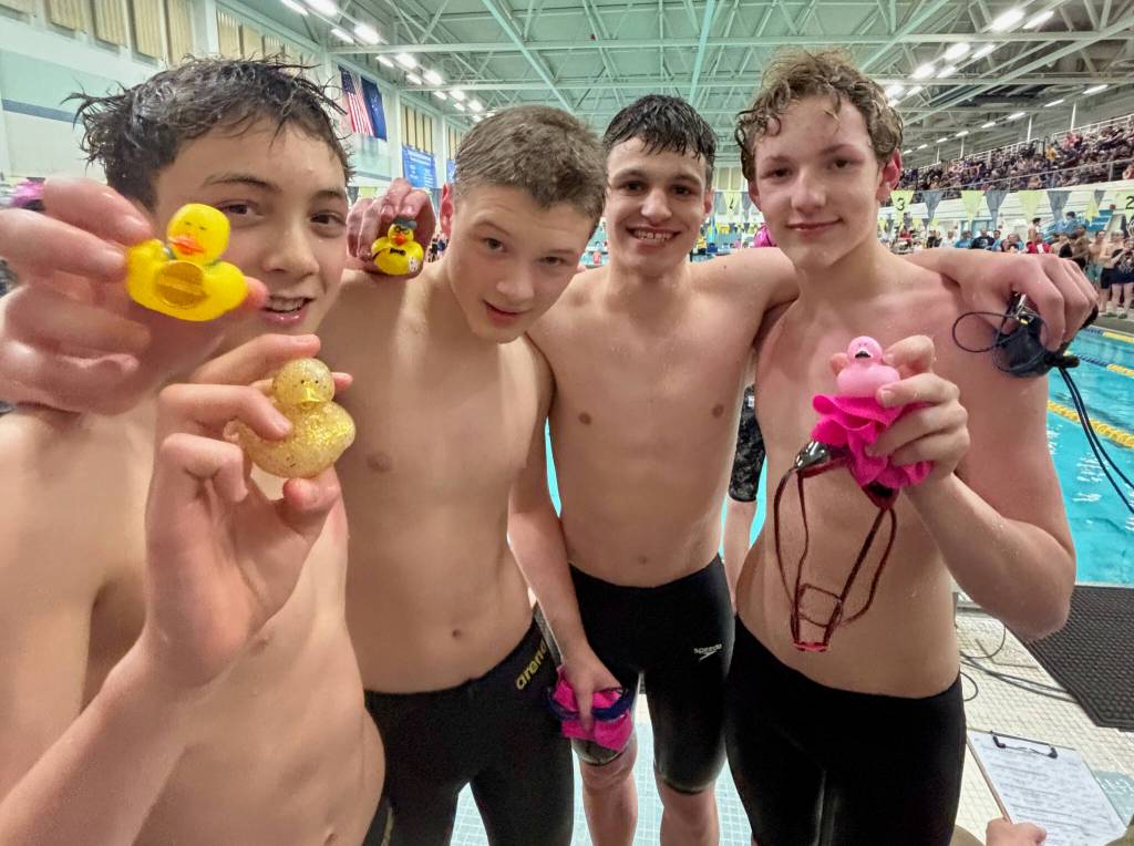 Glacier Swim Club swimmers Andy Huffer, Henry Thatcher, Levi Phelps and Zach Holden hold their heat winning ducks during the Alaska Swimming State Championships last weekend in Anchorage. (Photo courtesy GSC)