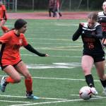 Juneau-Douglas High School: Yadaa.at Kalé sophomore forward Clairee Overson (18) moves a ball past West Anchorage freshman Kiana Isenberg (28) during the Crimson Bears 0-0 tie with the Eagles on Friday at Adair Kennedy Memorial Park. Overson earned the Crimson Bears Hard Hat Award in the game. (Klas Stolpe / Juneau Empire)