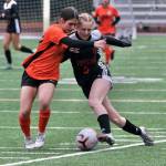 Juneau-Douglas High School: Yadaa.at Kalé junior forward Peyton Wheeler (5) wins a ball against West Anchorage freshman Noora Janjua (24) during the Crimson Bears 0-0 tie with the Eagles on Friday at Adair Kennedy Memorial Park. (Klas Stolpe / Juneau Empire)
