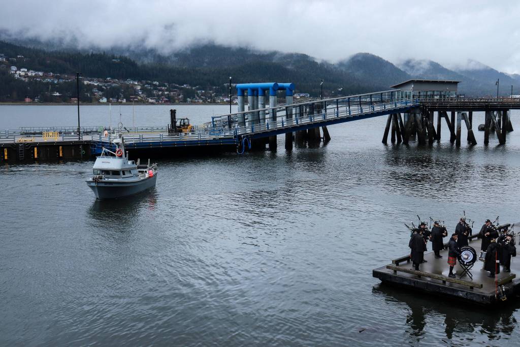The fishing vessel Sentinel arrives for its blessing while the City of Juneau Pipe Band performs. (Jasz Garrett / Juneau Empire)