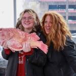 Ava and Sheila Sluka, from Arizona, volunteer with the Twisted Fish at the Juneau Maritime Festival on Saturday, May 3, 2025. (Jasz Garrett / Juneau Empire)