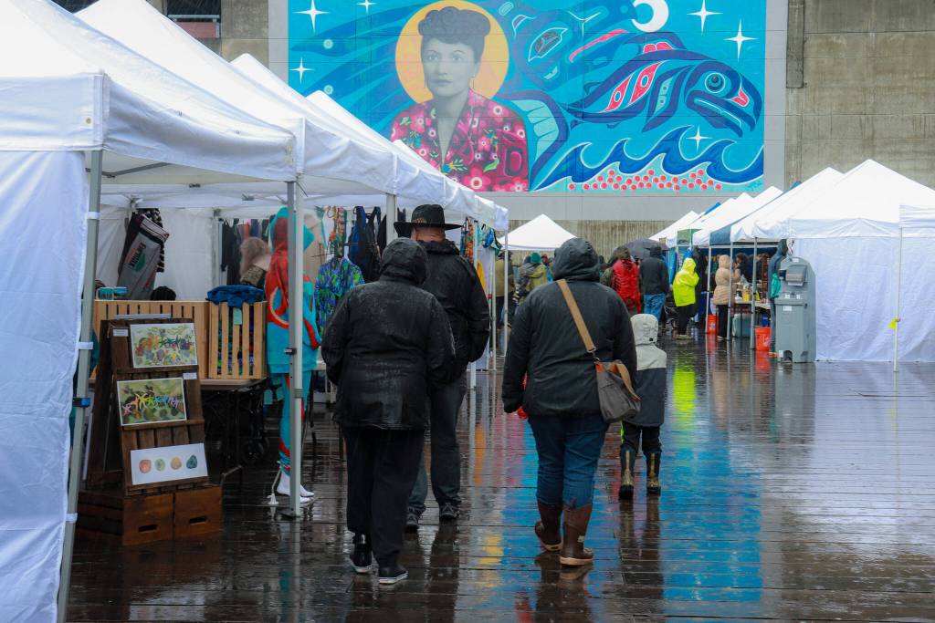People walk by vendor booths at the Juneau Maritime Festival on Saturday, May 3, 2025. (Jasz Garrett / Juneau Empire)