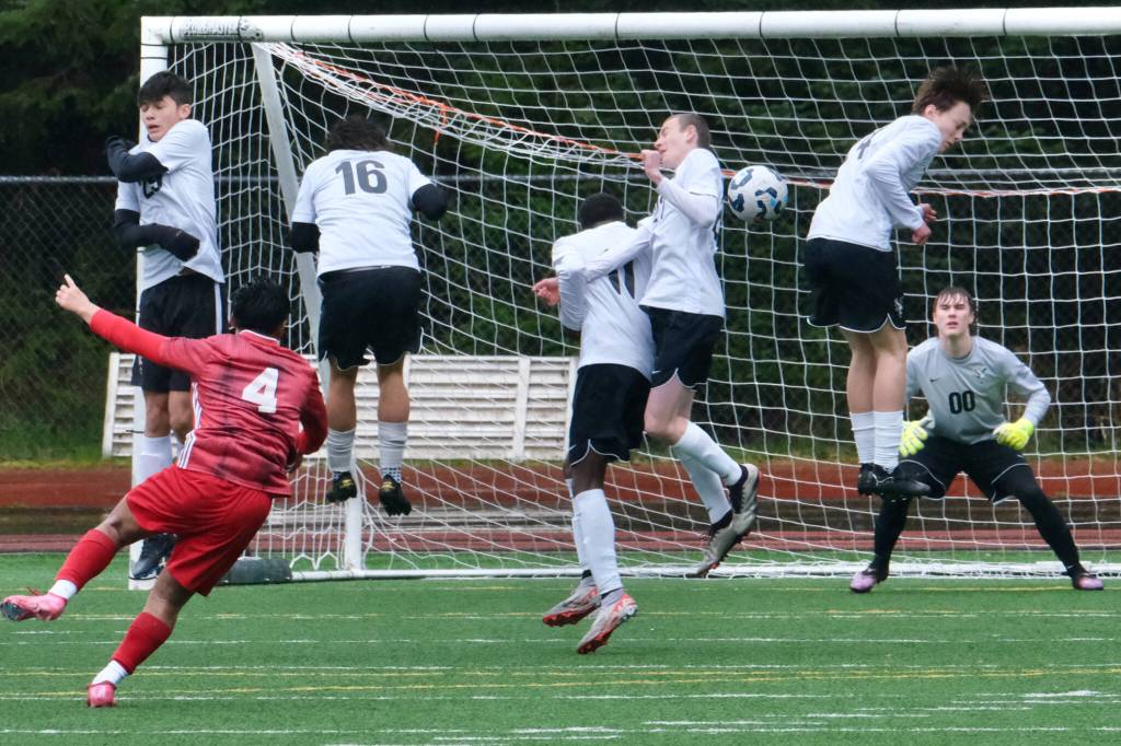Juneau-Douglas High School: Yadaa.at Kalé sophomore Sam Mazon (4) puts a free kick against the West Anchorage defense during the Crimson Bears 7-1 loss to the Eagles on Saturday at Adair Kennedy Memorial Park. (Klas Stolpe / Juneau Empire)