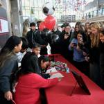 Family, friends and teammates of Juneau-Douglas High School: Yadaa.at Kalé senior Milina Mazon crowd in to watch her sign a Northwest Athletic Conference Letter of Intent on Monday in the JDHS commons to attend Edmonds College in Lynnwood, Washington, and play soccer for the Tritons. (Klas Stolpe / Juneau Empire)