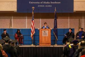 Selah Judge, who graduated with a Bachelor of Arts in social sciences, gives the student speech at the University of Alaska Southeast commencement on Sunday, May 4, 2025. (Jasz Garrett / Juneau Empire)