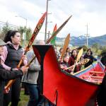 Wayne Price, master carver, (left) dances with his healing dugout canoe at Twin Lakes beside the community healing totem Kaasei Satú in a show of solidarity on Monday, May 5, 2025. (Jasz Garrett / Juneau Empire)