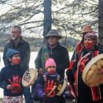 Jes Lxook Kinville-James (far right) leads the Stolen Prayers song on Monday, May 5, 2025. Kanaagoot Mike Kinvilles t-shirt, sponsored by Sealaska Heritage Institute, is worn. (Jasz Garrett / Juneau Empire)