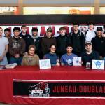 Juneau-Douglas High School: Yadaa.at Kalé senior Pedrin Saceda-Hurt signed an NCAA Division III student-athlete form on Wednesday in the JDHS commons to attend Luther College in Decorah, Iowa and play for the Norse basketball team. Shown are family, friends, coaches and team members attending. (Klas Stolpe/Juneau Empire)