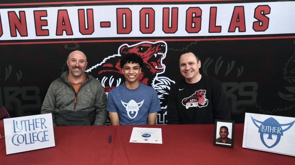 Juneau-Douglas High School: Yadaa.at Kaléenior Pedrin Saceda-Hurt signed an NCAA Division III student-athlete form on Wednesday in the JDHS commons to attend Luther College in Decorah, Iowa and play for the Norse basketball team. Shown are former Thunder Mountain coach John Blasco, Pedrin Saceda-Hurt and JDHS coach Robert Casperson. (Klas Stolpe/Juneau Empire)