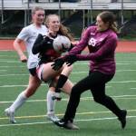 Juneau-Douglas High School: Yadaa.at Kalé junior Peyton Wheeler (5) has a shot stopped by Soldotna sophomore keeper Ryan Queen (55) as Stars senior Kendra Rose trails the play during the Crimson Bears 2-1 loss to the Stars on Thursday at Adair Kennedy Memorial Park. (Klas Stolpe/ Juneau Empire)