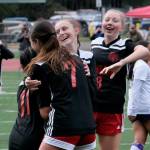 Juneau-Douglas High School: Yadaa.at Kalé senior Milina Mazon (11), junior Kenzie Simonson, junior Peyton Wheeler and sophomore Riley Schultz (8) celebrate a goal by Wheeler during the Crimson Bears 2-1 loss to the Stars on Thursday at Adair Kennedy Memorial Park. (Klas Stolpe/ Juneau Empire)