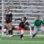 Juneau-Douglas High School: Yadaa.at Kalé senior Adelyn Buss (3) clears a ball from the Crimson Bears box as Soldotna senior Sadie Lane (11) and sophomore Teagen Kobylarz and JDHS senior Ella Orsborn (9) and junior Alba Muir (1) react during the Crimson Bears 2-1 loss to the Stars on Thursday at Adair Kennedy Memorial Park. (Klas Stolpe/ Juneau Empire)