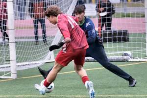 Juneau-Douglas High School: Yadaa.at Kalé senior Kai Ciambor (14) has his shot blocked by Soldotna junior keeper Luke Hillyer during the Crimson Bears 3-0 win over the Stars on Thursday at Adair Kennedy Memorial Park. (Klas Stolpe / Juneau Empire)