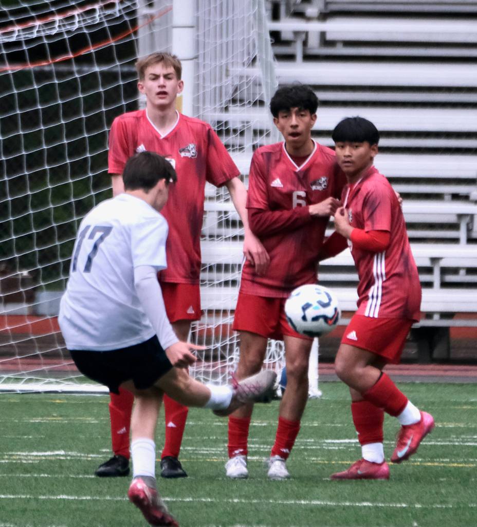 Juneau-Douglas High School: Yadaa.at Kalé senior Owen Rumsey, junior Kevin Flores-Lopez (6) and sophomore Sam Mazon defend a free kick by Soldotna junior Lane Hillyer (17) during the Crimson Bears 3-0 win over the Stars on Thursday at Adair Kennedy Memorial Park. (Klas Stolpe / Juneau Empire)
