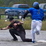 Juneau-Douglas High School: Yadaa.at Kalé junior first baseman Riley Fick (22) attempts to catch an errant throw as Petersburg senior Brian Peterson (7) runs out a hit during the Crimson Bears 12-7 win over the Vikings on Friday at Mort Fryer Ball Park in Petersburg. (Klas Stolpe / Juneau Empire)