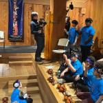 Axel Baumann films and Max Osadchenko captures sounds of Juneau Alaska Music Matters students performing a Gratitude concert at the Sealaska Heritage Institute Clan House on Thursday, May 8, 2025. (Mark Sabbatini / Juneau Empire)
