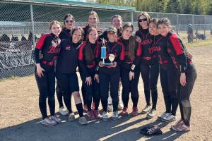 The Juneau-Douglas High School: Yadaa.at Kalé Crimson Bears softball team pose with their third-place trophy Saturday at the 2025 Blue & Gold Softball Tournament in Anchorage. (Photo courtesy JDHS softball)