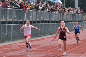 In this file photo Juneau-Douglas High School: Yadaa.at Kalé freshman Bella Connally, Ketchikan senior Clara Odden and Sitka junior Adalyna Moore race to the finish of the 4x100 relay during the Capital City Invitational Track & Field Meet in Juneau on April 26. (Klas Stolpe / Juneau Empire file photo)