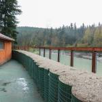 Phase One of the HESCO barriers ends in the backyard of this residence on Rivercourt Way on Monday, May 12, 2025. The next extension, Phase One A, will install the barriers along the river adjacent to Dimond Park from the end of Rivercourt Way, interconnecting through a gap in the back fence. (Jasz Garrett / Juneau Empire)