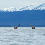 Ed Page and Jörg Knorr kayak together on Sunday, May 11, 2025. (Jasz Garrett / Juneau Empire)