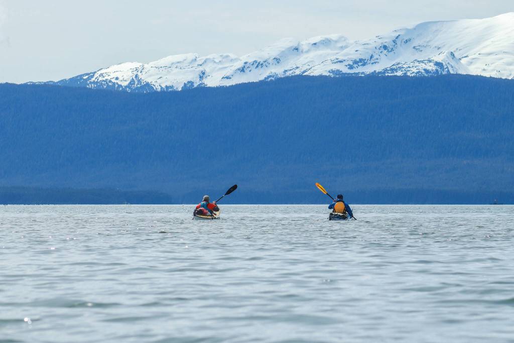 Ed Page and Jörg Knorr kayak together on Sunday, May 11, 2025. (Jasz Garrett / Juneau Empire)