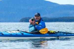 Jörg Knorr, a solo travel journalist from Flensburg, Germany, smiles after taking a photo on Sunday, May 11, 2025. (Jasz Garrett / Juneau Empire)