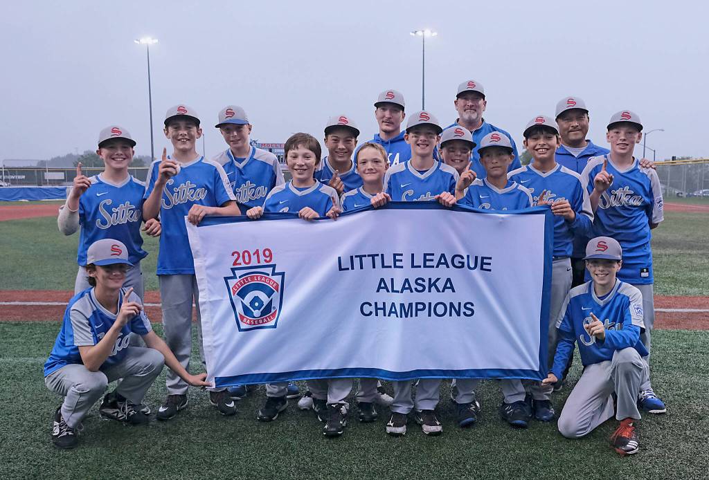In this file photo the 2019 Little League Alaska Majors Baseball All-Stars Champions from Sitka L.L. pose for a photo at Moller Field after defeating Knik 6-5 to earn a trip to the Northwest Regionals in San Bernardino, California. Standing from left: Samson Smith, Emmit Johnson, Trey Johnson, Caleb Calhoun, Kai Hirai, Evan Grant, coach Ryne Calhoun, Bryce Calhoun, Brett Ross, coach Bob Calhoun, Josh McAlpin, Rawl Weathers, coach Rich McAlpin, and Mason Mcleod. Kneeling are Chance Coleman and Josh Gluth. Most of this roster currently play for the Sitka Wolves. (Klas Stolpe / Juneau Empire)