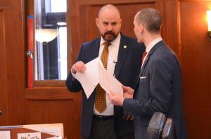 Rep. Jeremy Bynum, R-Ketchikan, speaks to Rep. Calvin Schrage, I-Anchorage, during a vote on amendments to the states capital budget on Monday, May 12, 2025. (James Brooks/Alaska Beacon)