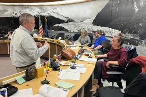 Eaglecrest Ski Area Board President Mike Satre (left) confers with Juneau Assembly member Christine Woll during an Assembly Finance Committee meeting Wednesday, May 14, 2025, at City Hall. (Mark Sabbatini / Juneau Empire)