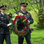 Detective Mattie Shriver and officer Aron Landry, honor guards for the Juneau Police Department, carry a wreath to lay at the grave of Chief of Detectives Donald Dull, the first Juneau officer who died in the line of duty in 1964. (Jasz Garrett / Juneau Empire)