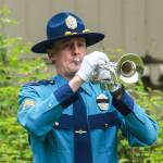 Alaska Wildlife Trooper Sgt. Branden Forst plays a trumpet during the laying of wreaths on Friday, May 16, 2025. (Jasz Garrett / Juneau Empire)