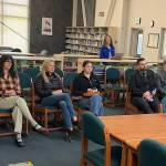 Brenda Taylor (right) smiles at Steve Whitney as he is named to the Juneau Board of Education among five candidates considered Saturday, May 17, 2025, in the library at Thunder Mountain Middle School. Besides Taylor and Whitney, the candidates were Melissa Cullum (second from left), Jenny Thomas (third from left) and Dom Pannone (third from right). (Mark Sabbatini / Juneau Empire)