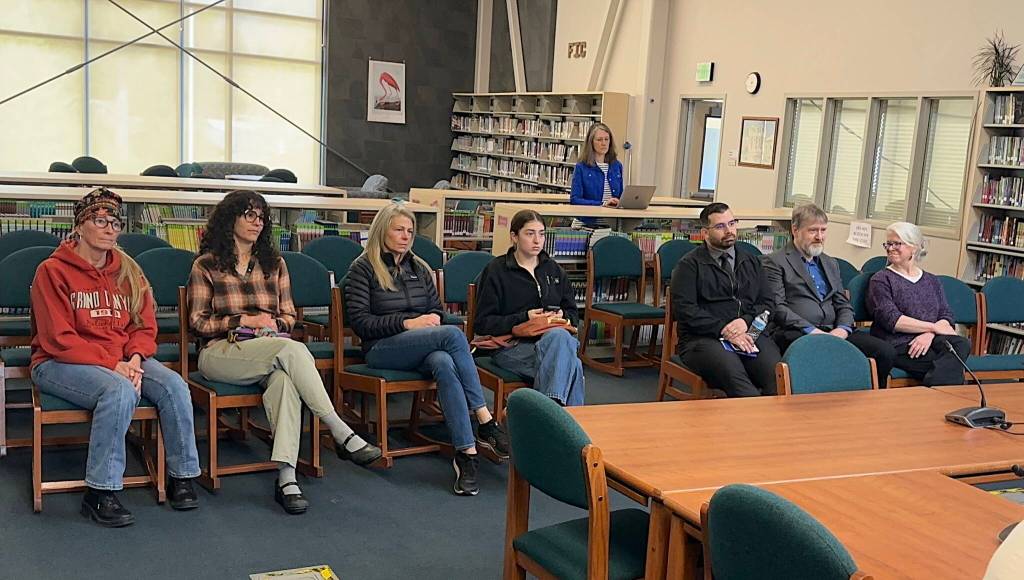 Brenda Taylor (right) smiles at Steve Whitney as he is named to the Juneau Board of Education among five candidates considered Saturday, May 17, 2025, in the library at Thunder Mountain Middle School. Besides Taylor and Whitney, the candidates were Melissa Cullum (second from left), Jenny Thomas (third from left) and Dom Pannone (third from right). (Mark Sabbatini / Juneau Empire)