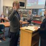 Steve Whitney (left) is sworn in as a Juneau Board of Education member by Superior Court Judge Amy Mead in the library at Thunder Mountain Middle School on Saturday, May 17, 2025, after five candidates were interviewed by the other board members to fill the seat vacated when Will Muldoon resigned last month. (Mark Sabbatini / Juneau Empire)