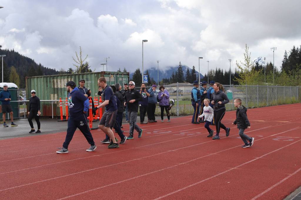 Runners move from the track onto the trail during the annual Alaska Law Enforcement Torch Run on Saturday, May 17, 2025. (Ellie Ruel / Juneau Empire)