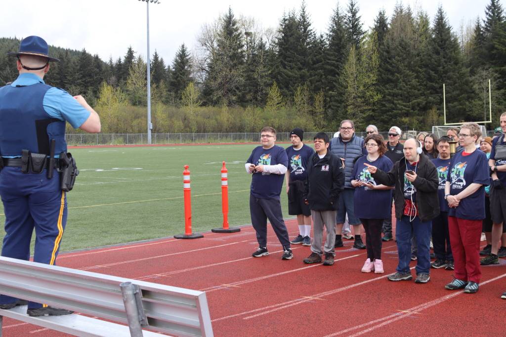 Sgt. Chris Russell (left) explains the route before the start of the annual Alaska Law Enforcement Torch Run at Thunder Mountain Middle School on Saturday, May 17, 2025. (Ellie Ruel / Juneau Empire)