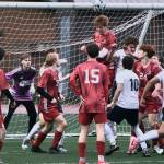 In this file photo from last weeks home win against Soldotna the Juneau-Douglas High School: Yadaa.at Kalé back defense of Ryan Thibodeau (12), keeper Callen Walker, Elliott Welch (35), Bryce Haygood (15), Reed Maier (19) heading the ball, Erik Thompson (24) and Owen Rumsey defend the box in a win over the Stars. (Klas Stolpe / Juneau Empire file photo)