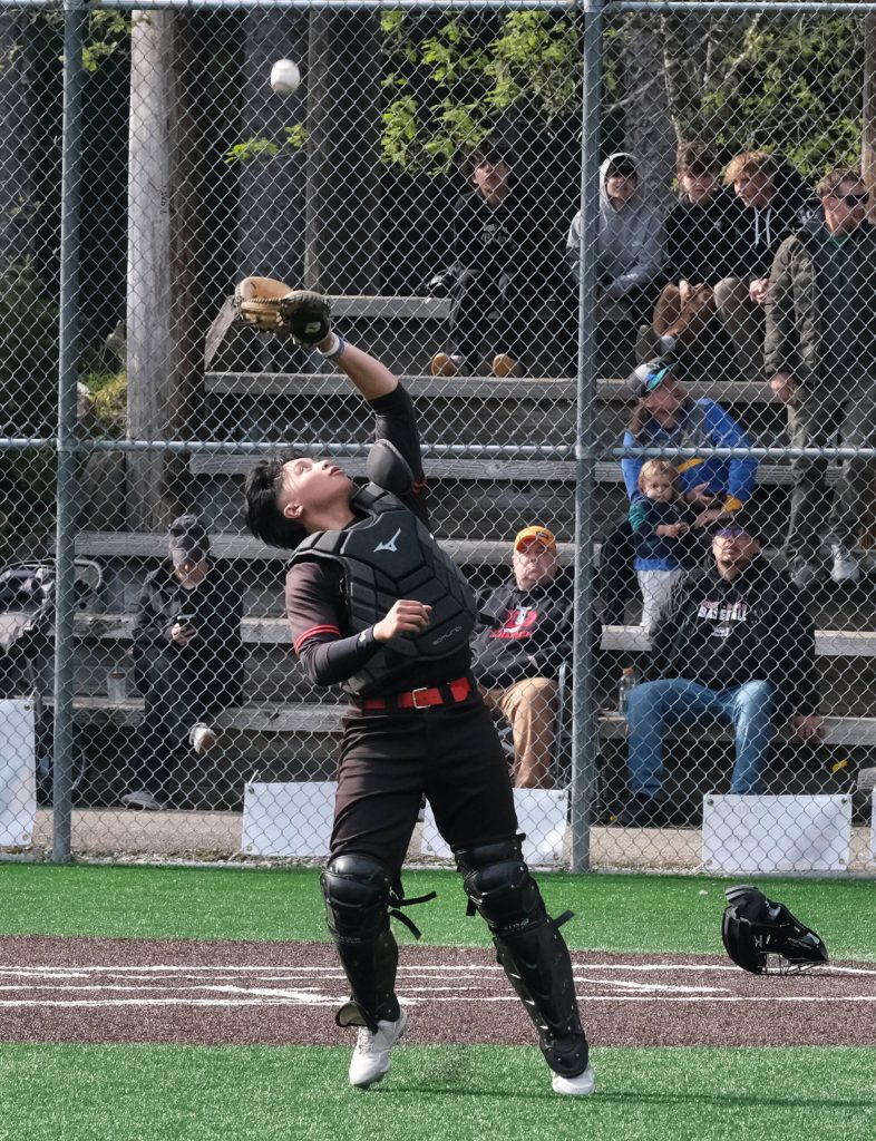 JDHS senior catcher JJ McCormick settles under a foul ball during the Crimson Bears’ baseball senior night against Ketchikan on Saturday at Adair-Kennedy Memorial Park. (Klas Stolpe / Juneau Empire)