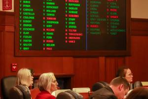 Rep. Andi Story (D-Juneau), Rep. Rebecca Himschoot (I-Sitka), and Rep. Sarah Vance (R-Homer) watch the vote tally during a veto override joint session on an education bill Tuesday, May 20, 2025. (Jasz Garrett / Juneau Empire)