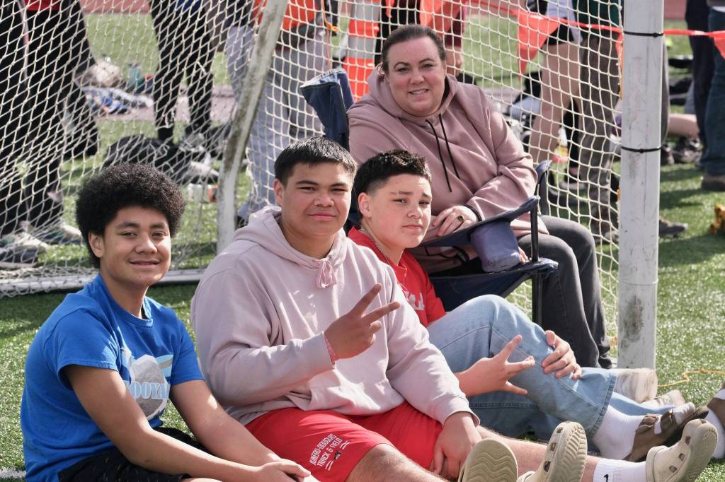 Juneau-Douglas High School: Yadaa.at Kalé junior Richard Tupou flashes a peace sign while sitting with family members during the Capital City Invitational this year. Tupou is among the shot put favorites for this weekend's Region V championships at Thunder Mountain Middle School. (Klas Stolpe / Juneau Empire)
