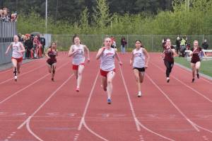 Klas Stolpe / Juneau Empire
Juneau-Douglas High School: Yadaa.at Kalé freshman sprinter Bella Connally (4) wins the girls 100-meters in a Crimson Bears sweep as classmates Lydia Goins (7), Addie Hartman (5) and Shandiin Frommherz (3) trail her across the finish during the Region V Track & Field Championships at Juneaus Thunder Mountain Middle School on Friday.