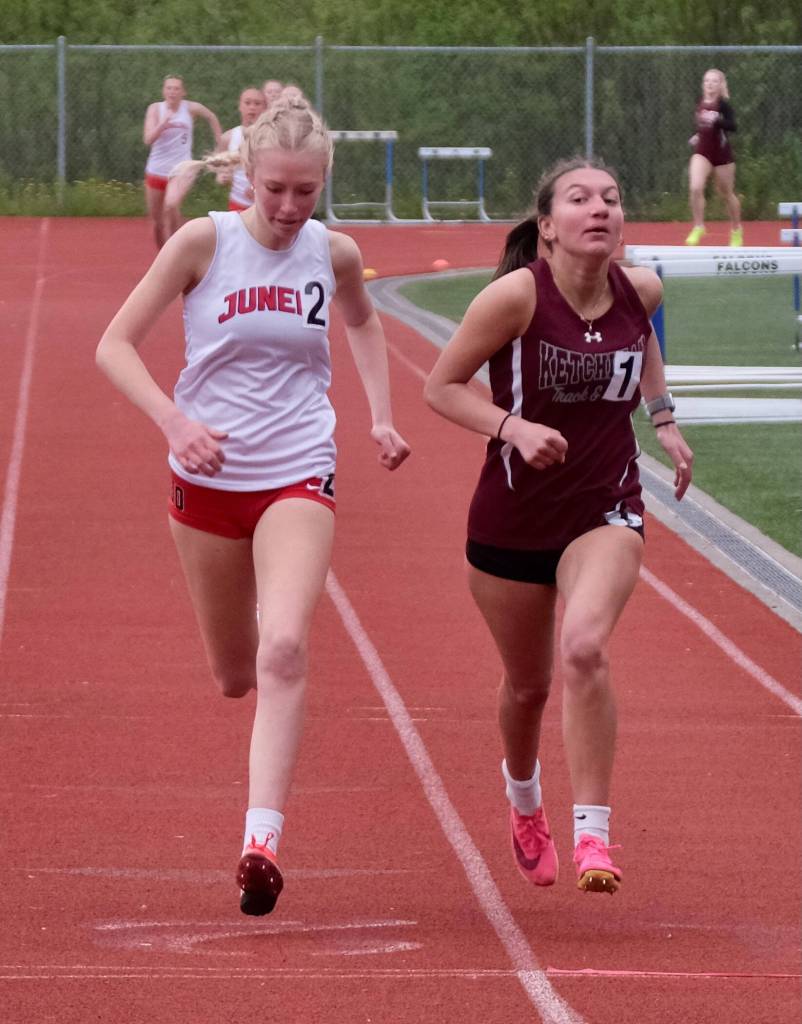 Juneau-Douglas High School: Yadaa.at Kalés Sigrid Eller and Ketchikans Carol Frey cross the finish line of the girls 800 meter race during the Region V Track & Field Championships at Juneaus Thunder Mountain Middle School on Friday. Frey won by .02 seconds. (Klas Stolpe / Juneau Empire)