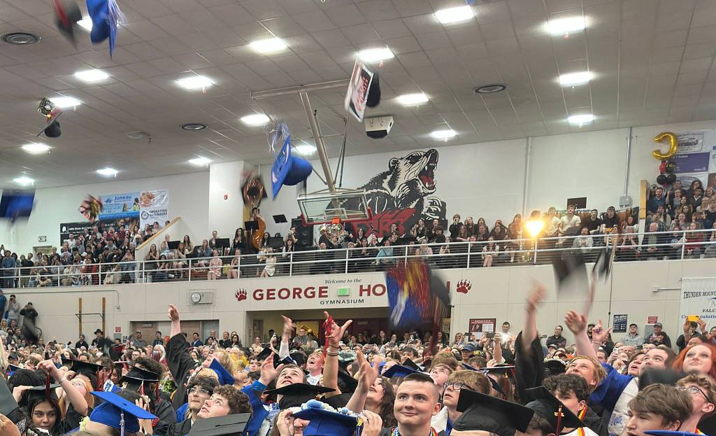 Newly graduated students from Juneau-Douglas High School: Yadaa.at Kalé toss their caps at the end of their commencement ceremony on Sunday, May 25, 2025. (Mark Sabbatini / Juneau Empire)